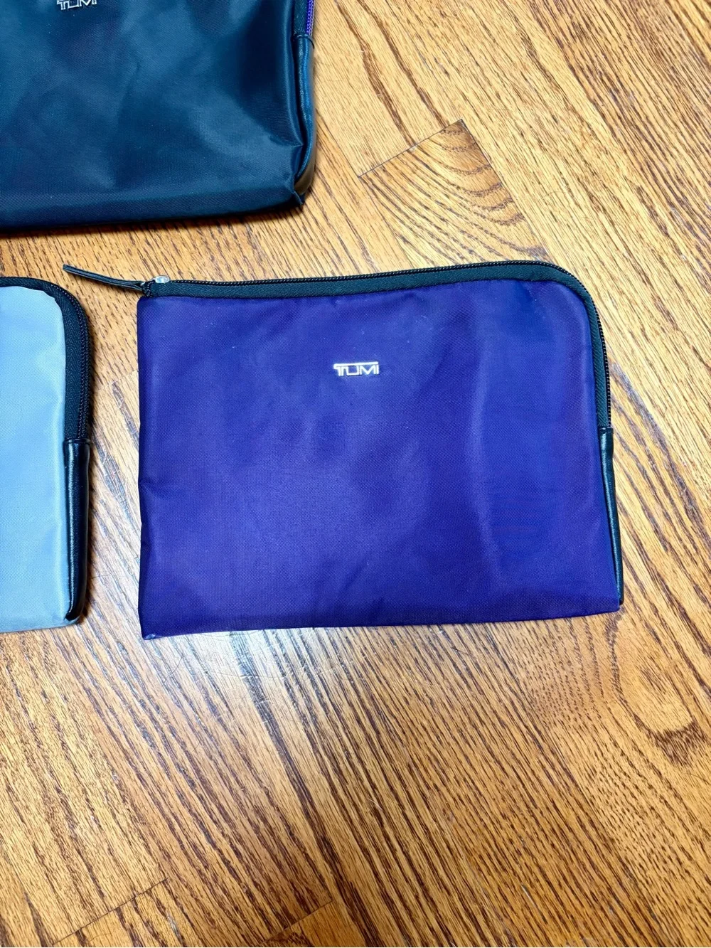 Set of Three TUMI Travel Pouches in Purple, Black & Gray